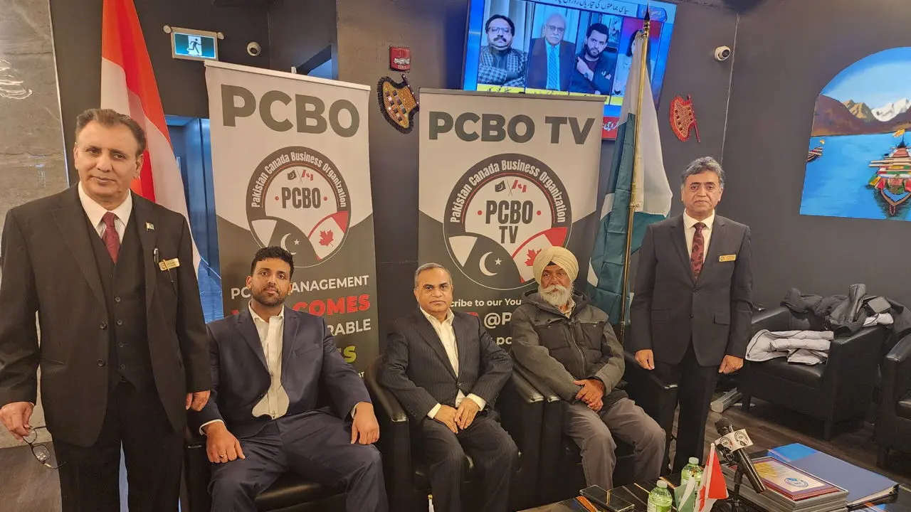 Members in suits at the PCBO Annual Holiday Gathering, between the Canadian and Pakistani flags