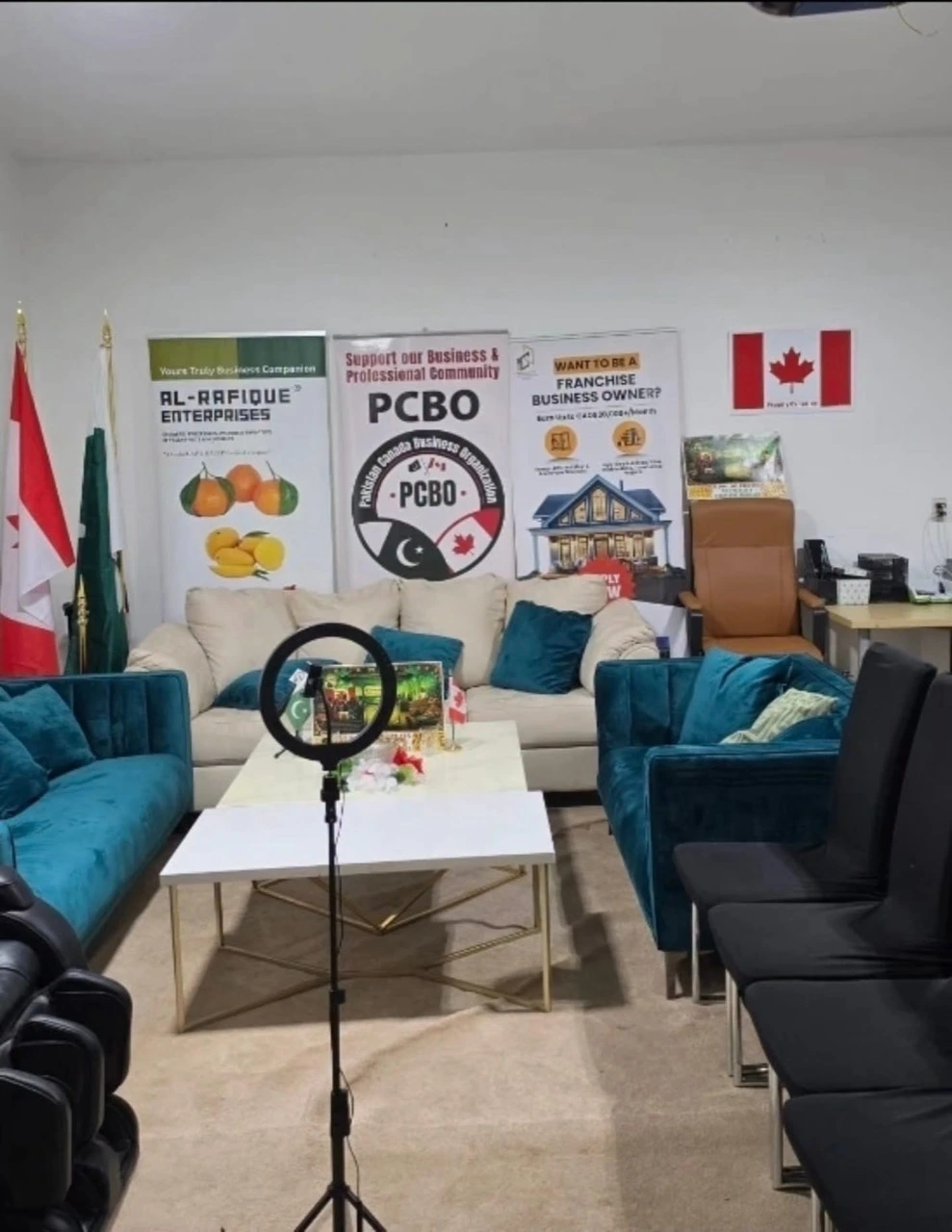 The PCBO TV set with sofas, a ring light, Canadian and Pakistani flags, and sponsor banners